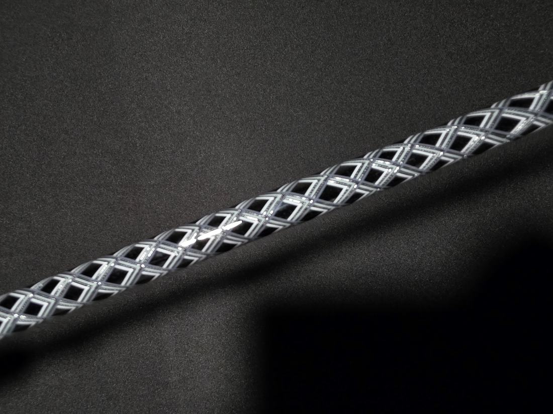 Dark woven carbon-style rod grip on black background