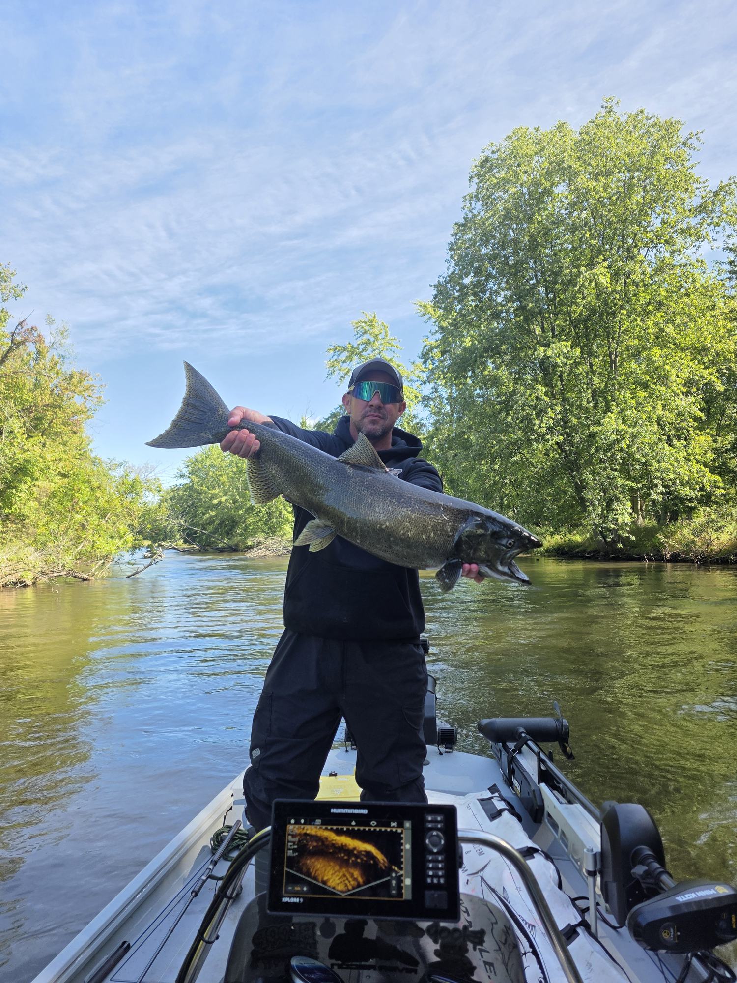 Angler holding a large fish on the river